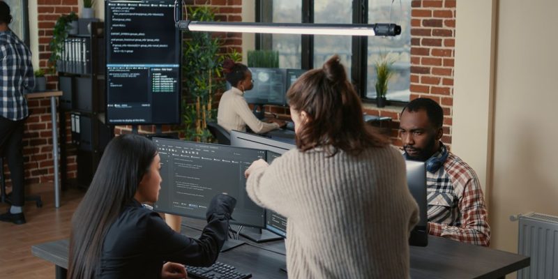 Equipo de desarrollo colaborando con el cliente en la creación de software personalizado